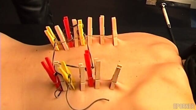 Blonde Woman Endures Painful Clothespins On Her Back