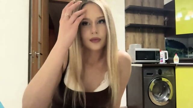 Sexy Blonde Woman In Brown Top And Black Shorts Posing In Kitchen