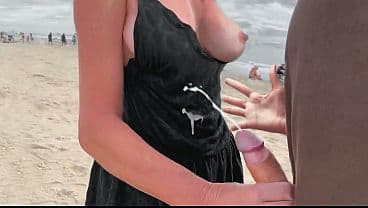 A milf jerk off a stranger on a public beach fo...